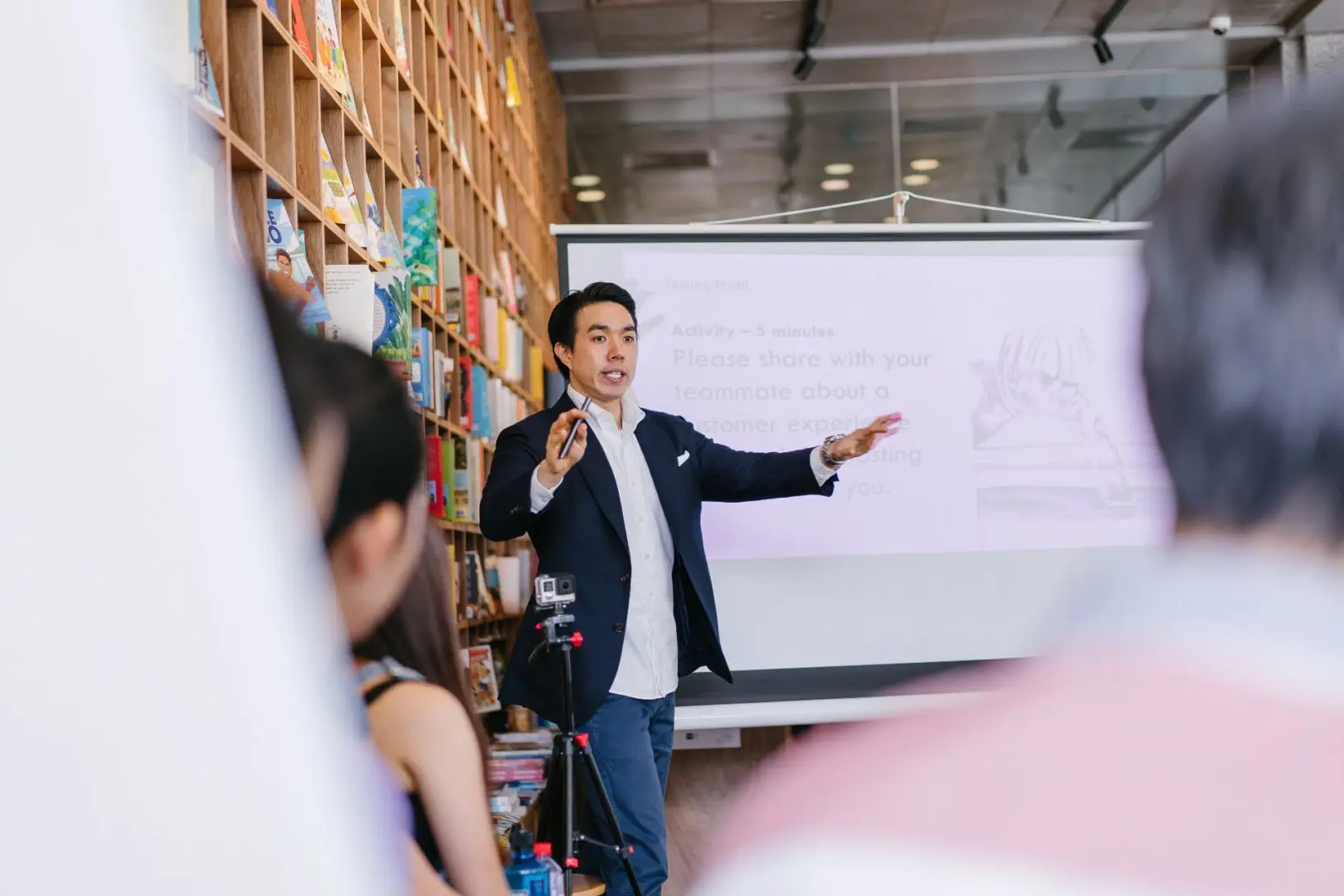Asian business man presenting to a group of audience members
