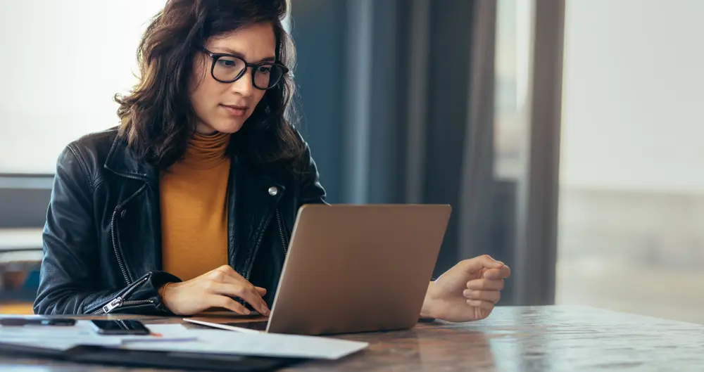 asian woman working on laptop computer
