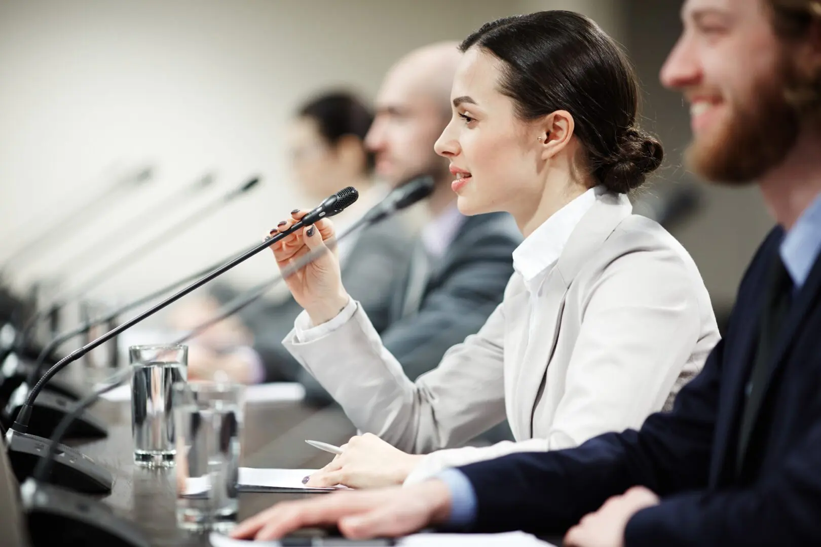 woman speaking into microphone at panel discussion